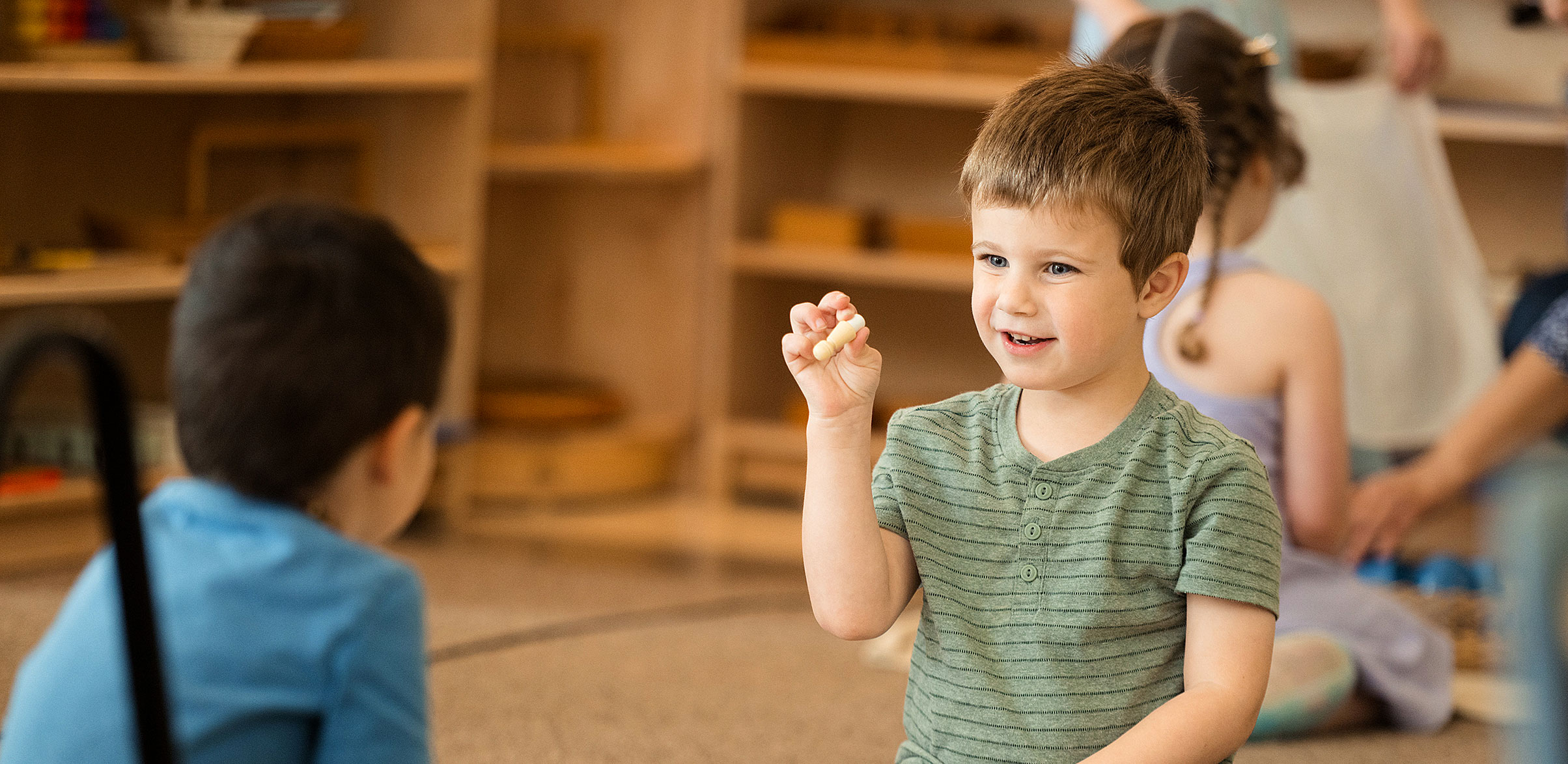 A child plays a game with a fellow student from Creative Montessori School.